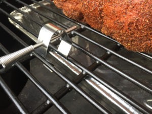 Securing an air probe to your smoker's grate with a grate clip.