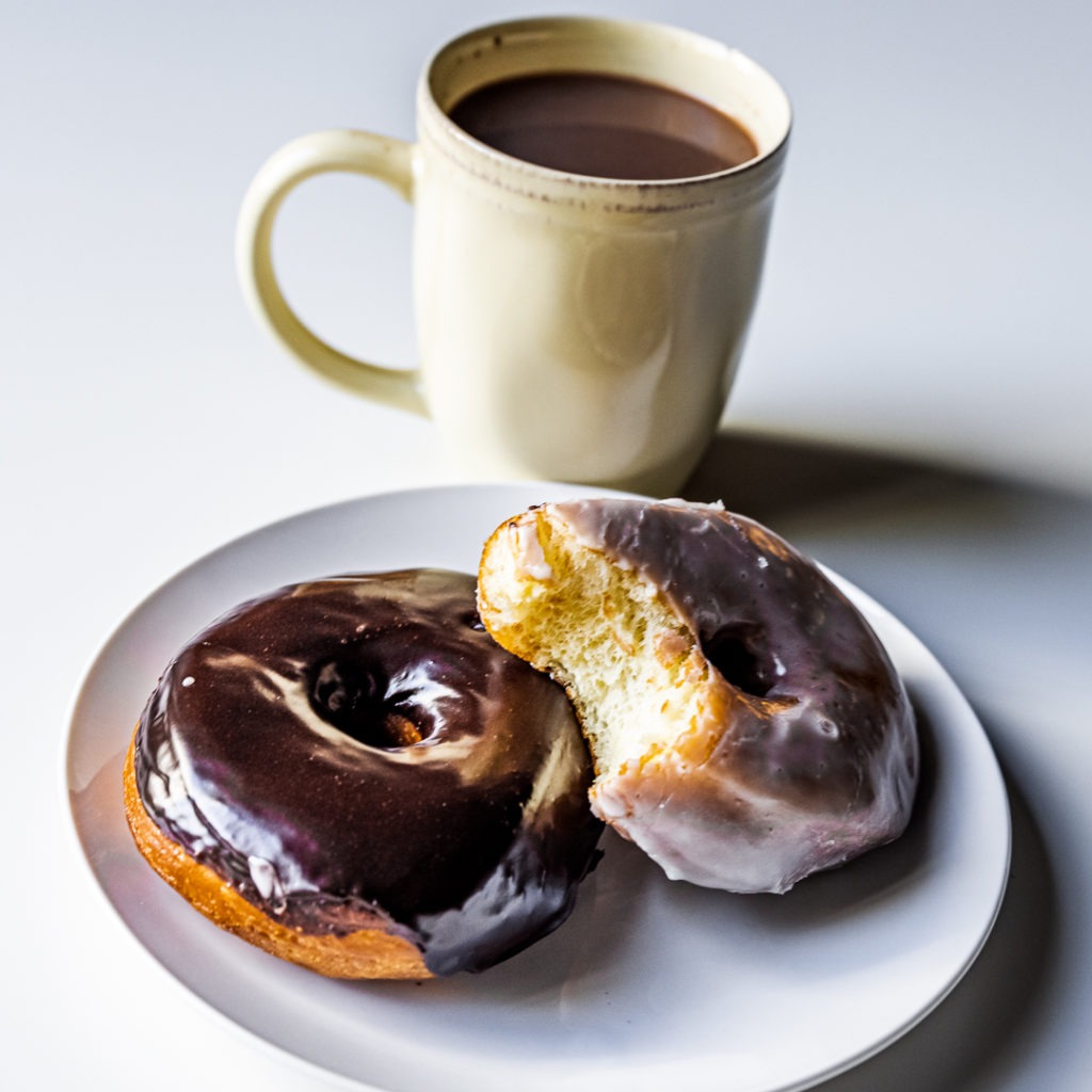Warm homemade donuts with a hot drink