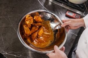 Tossing wings in sauce