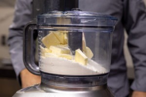 butter in processor on top of dry ingredients