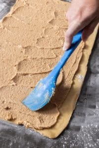 spreading the filling on the dough