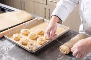 cutting the cinnamon rolls