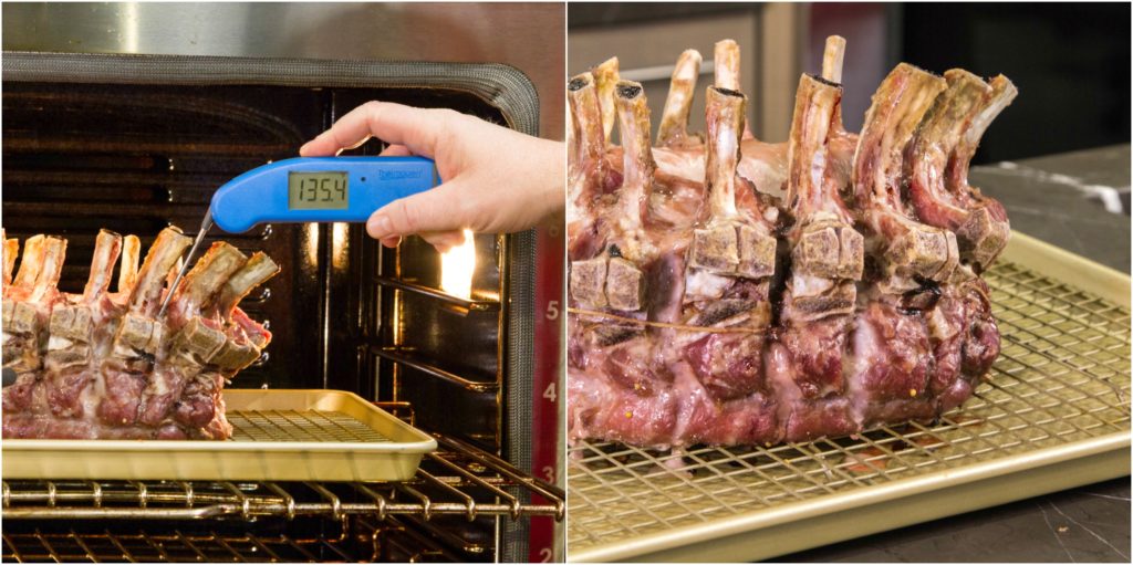 Verifying crown pork roast's pull temperature of 135°F with Thermapen.