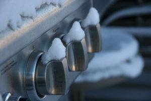 Snow covered knobs on a grill