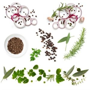 Food background collection with onions, herbs, and peppercorns, all isolated on white. Overhead view.