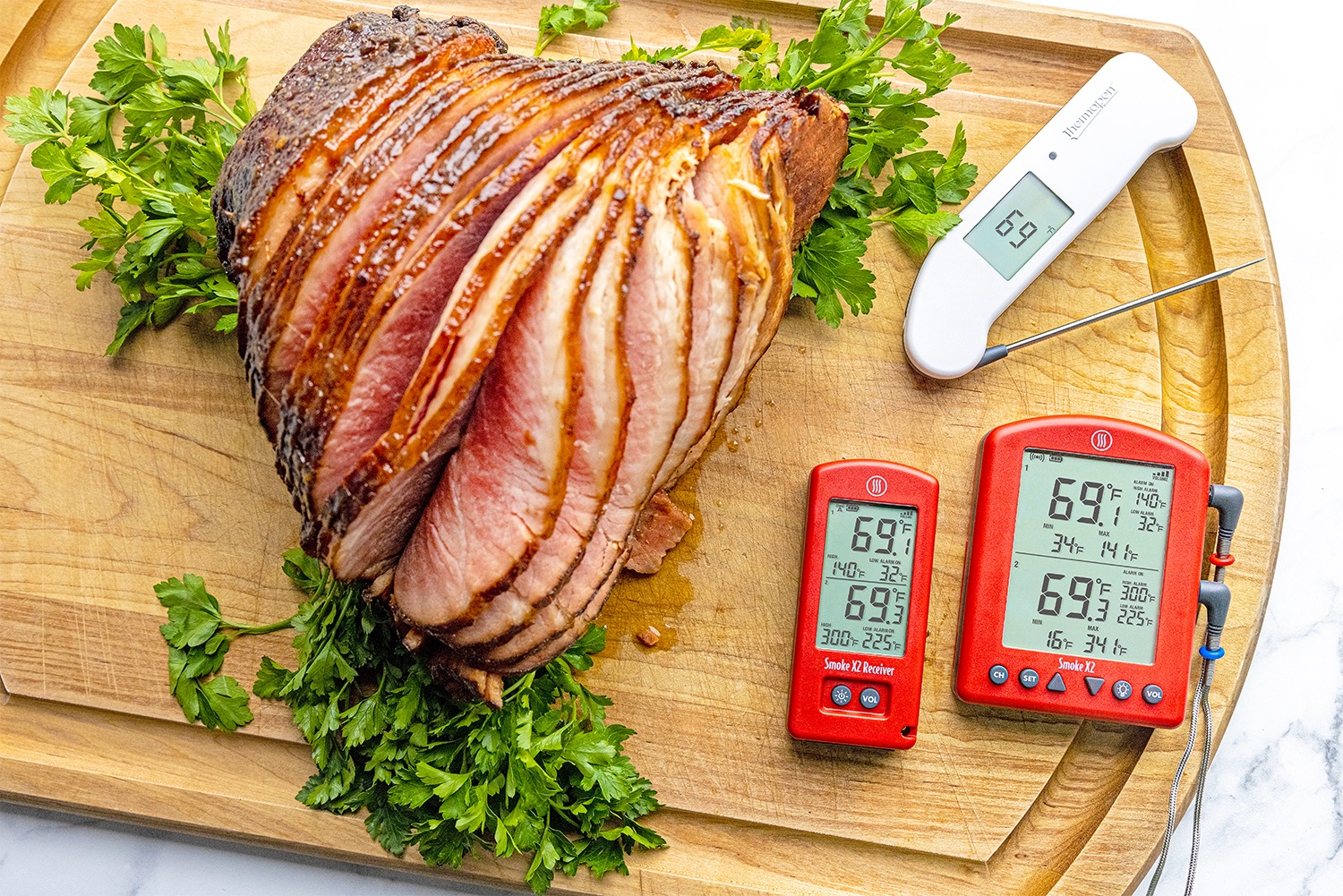 Ham on cutting board with thermometers