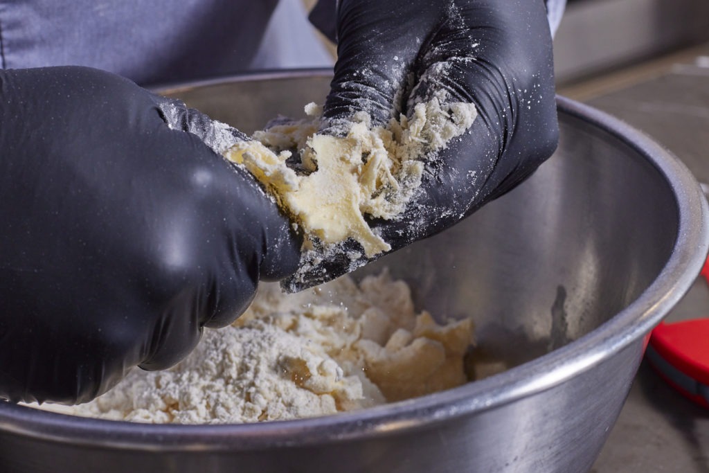 Flaking the fat into the flour for pie crust