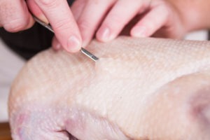Prick the goose's skin to facilitate fat rendering
