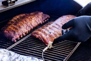 putting the ribs back in the smoker