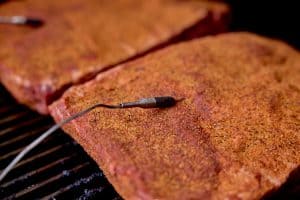 probed, sessoned ribs on the smoker