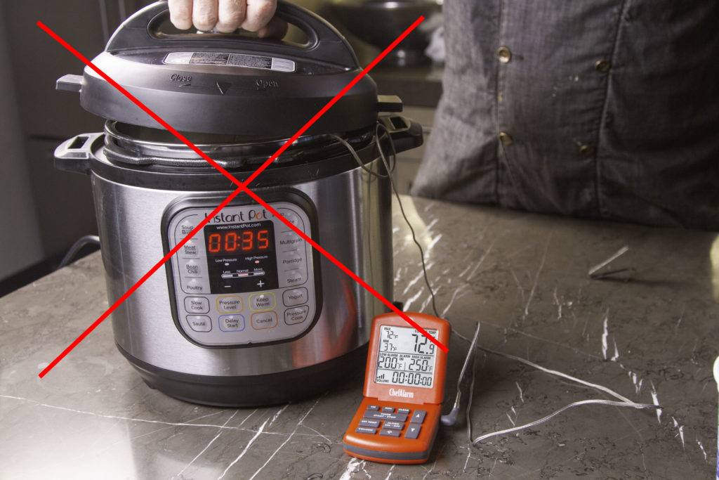 Putting a lid on over the thermometer cable is a no-no for pressure cookers
