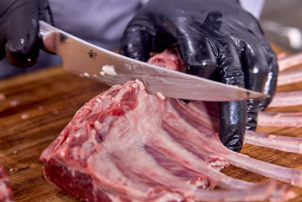 Cutting slits between lamb bones