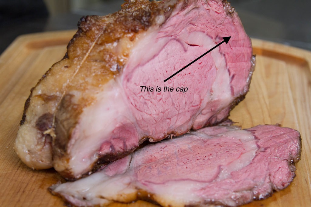 Picture of prime rib with arrow pointing to the ribeye cap
