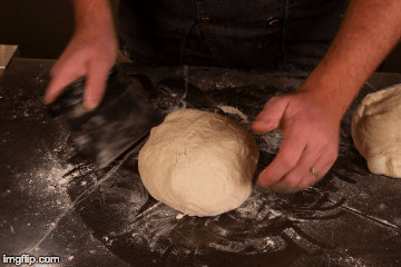 Use a scraper to press, tuck, and turn the dough to shape it