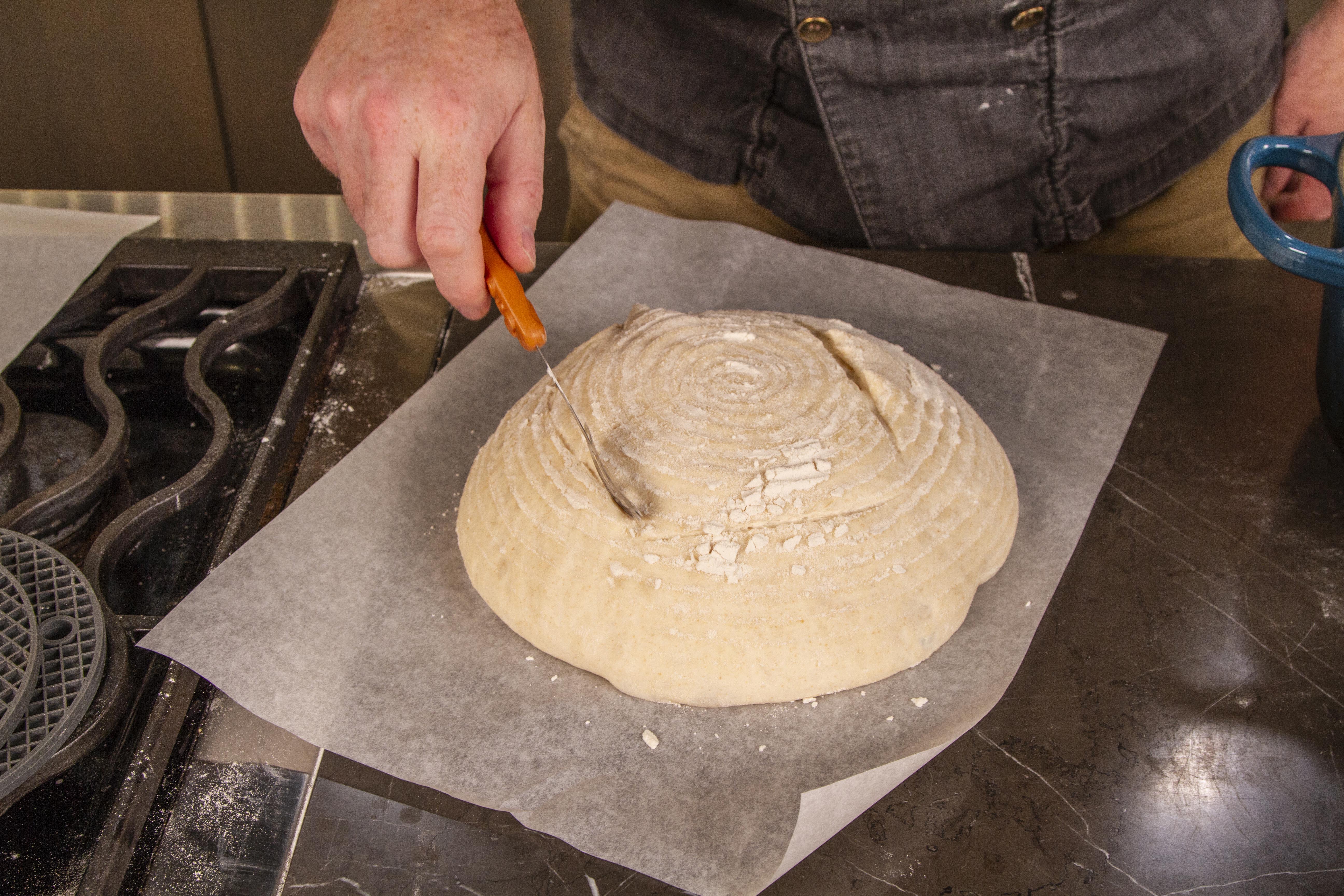 Score the top of the sourdough with a razorblade