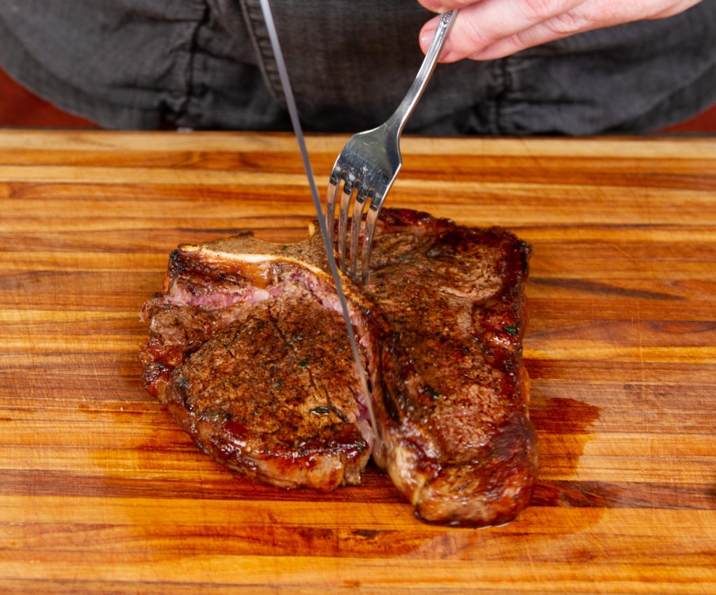Carve your porterhouse by cutting out each section.