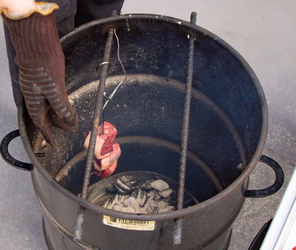 Hang the skewers in the barrel cooker or place them on the grill.