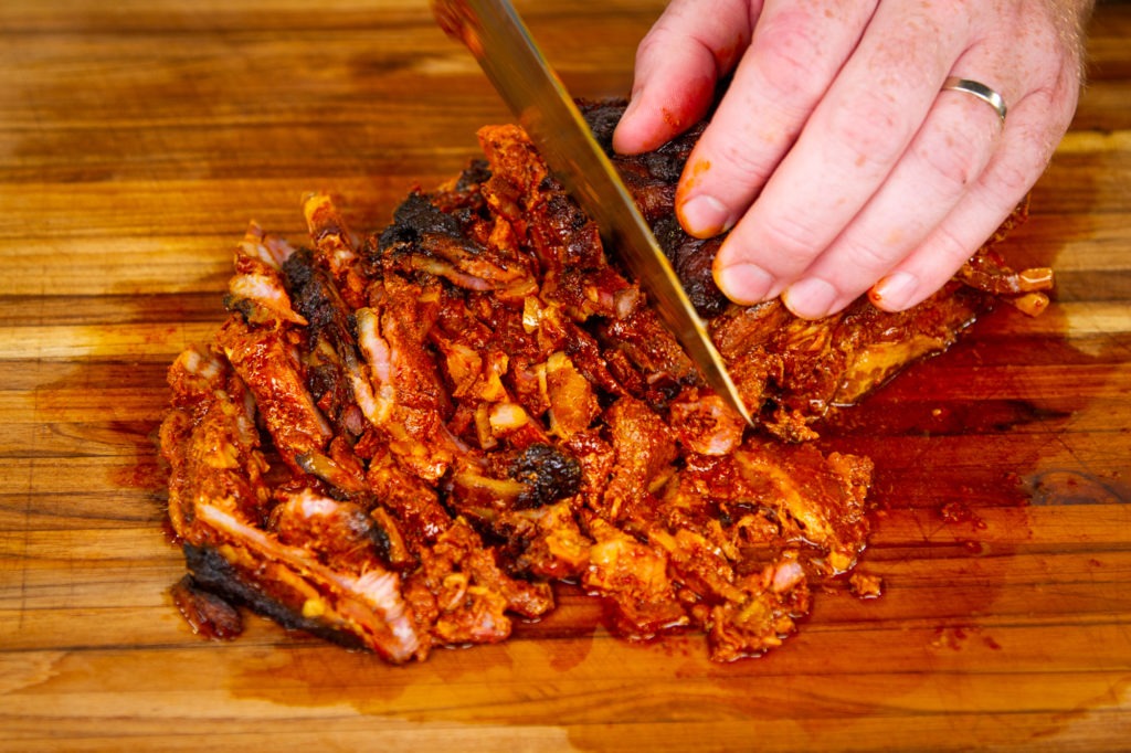Slice the al pastor meat