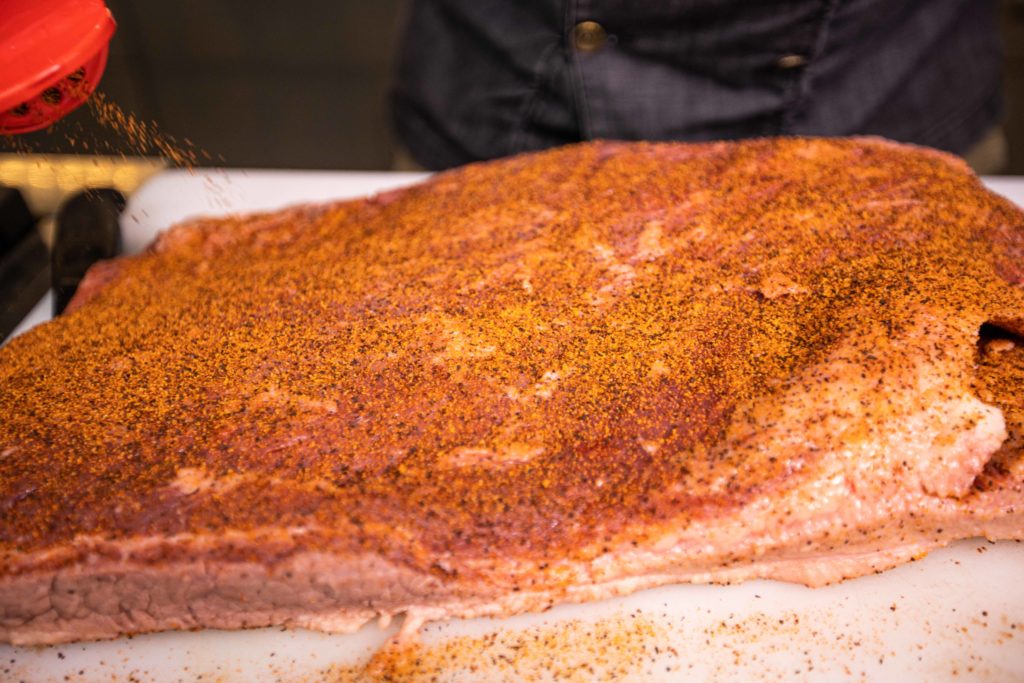 Season the brisket well with your favorite BBQ rub