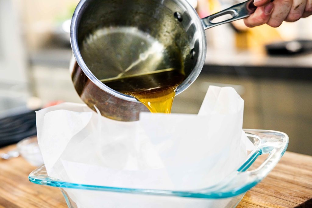 Pouring the liquid candy into a lined pan  for cooling