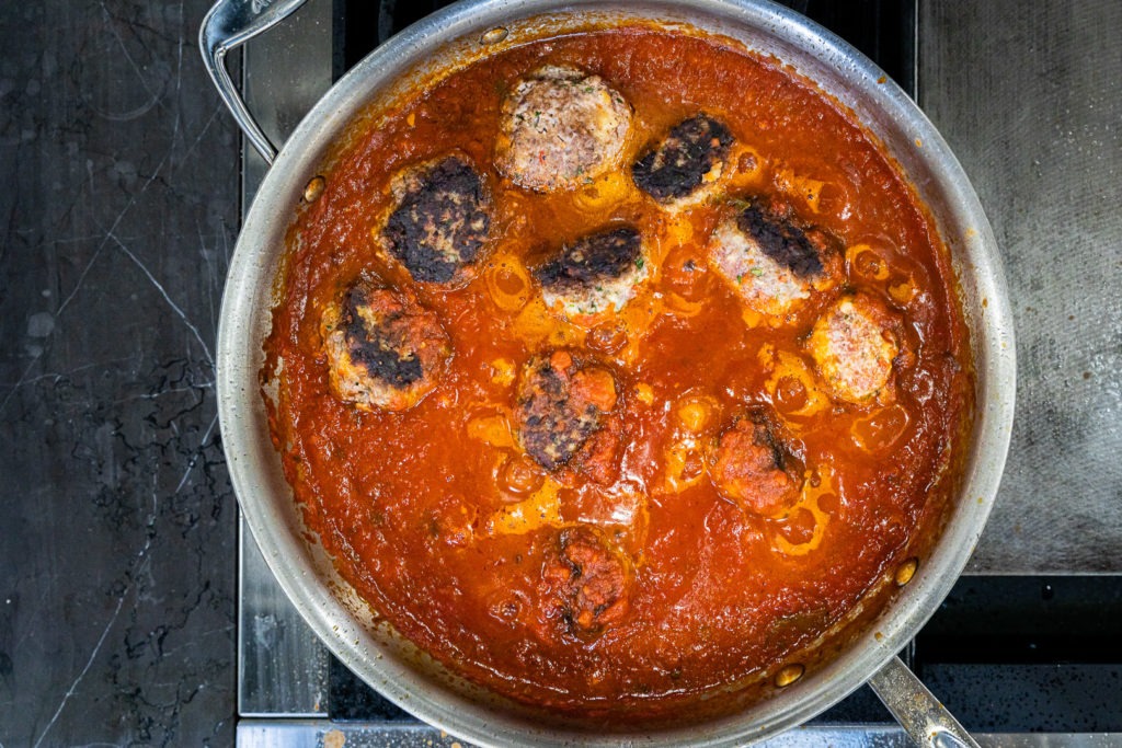 Simmering meatballs in pasta sauce