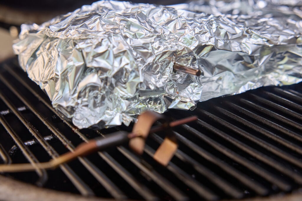The wrapped pork on the smoker