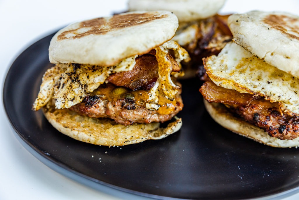 Grilled breakfast sandwiches with bacon, sausage, egg, and cheese
