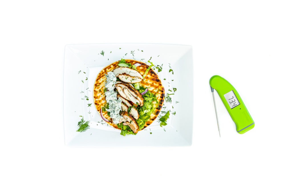 Chicken shawarma on a plate with a Thermapen next to it. 