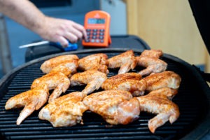 placing wings on the grill