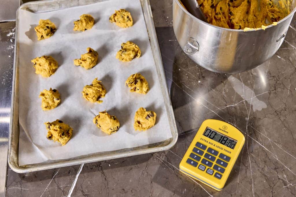 Cookies on pan ready to cook with timer next to them