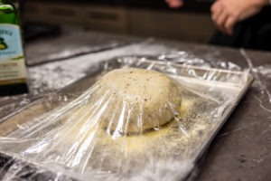 Dough ball, covered in oiled plastic