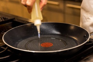 Adding oil to pan