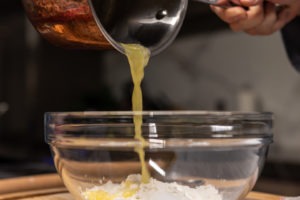 Pouring butter into streusel topping