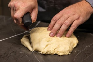 Cutting a small piece of dough