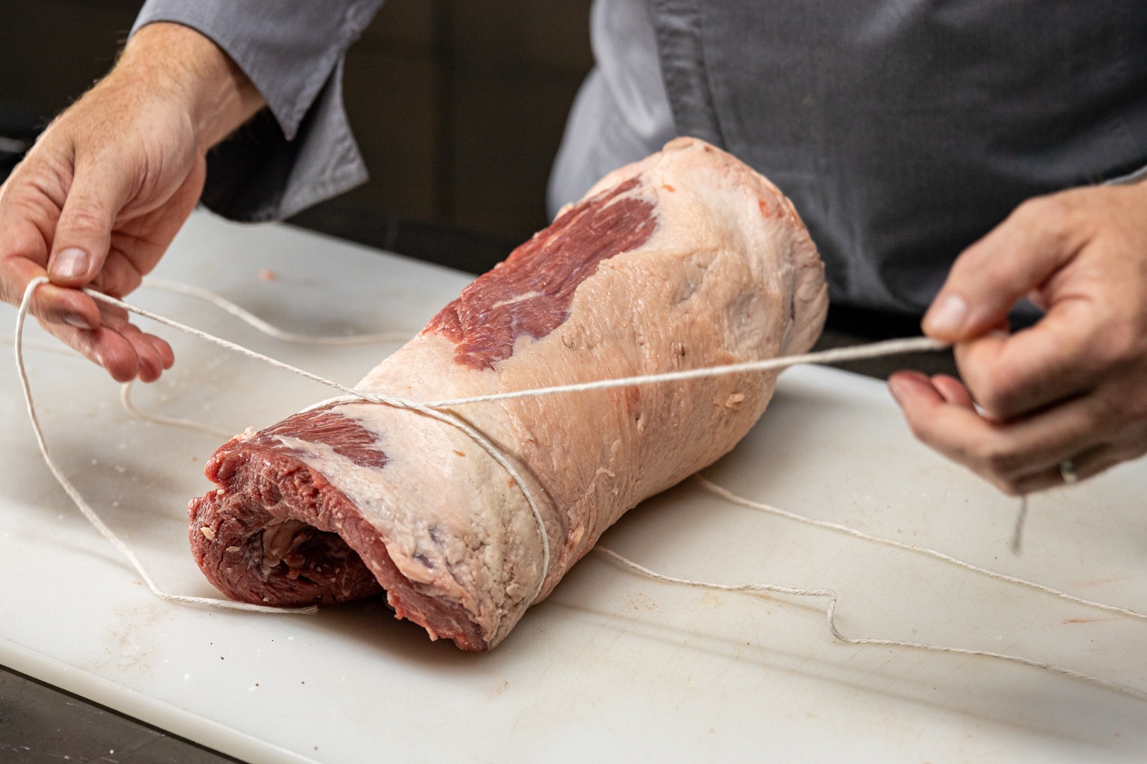 tying the rolled brisket