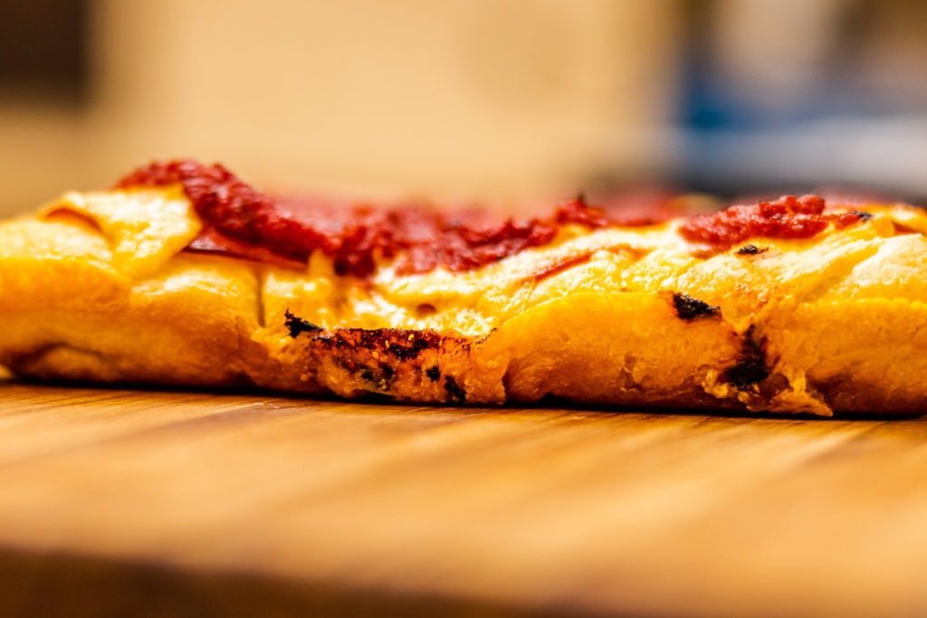 The crust of a Detroit-style pizza