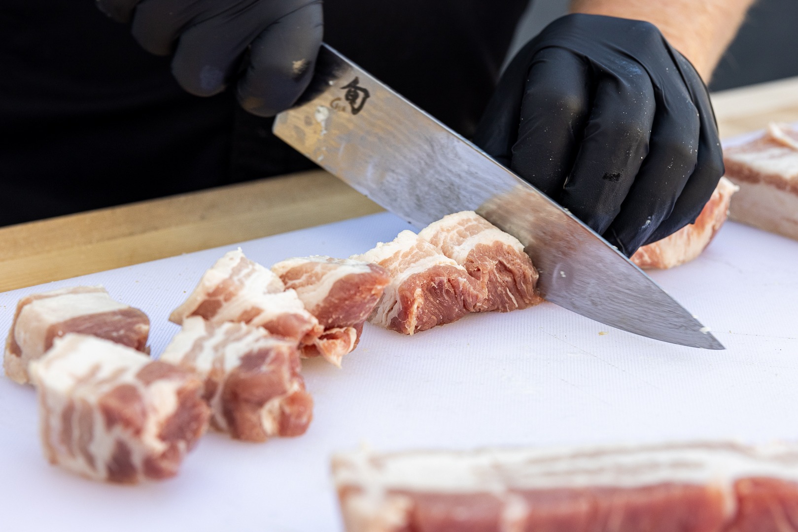 Cutting the pork belly into cubes