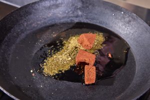 frying the spices in oil