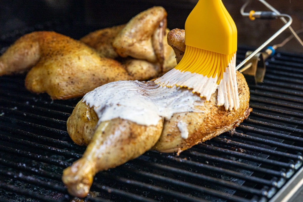 Basting chicken with Alabama white sauce