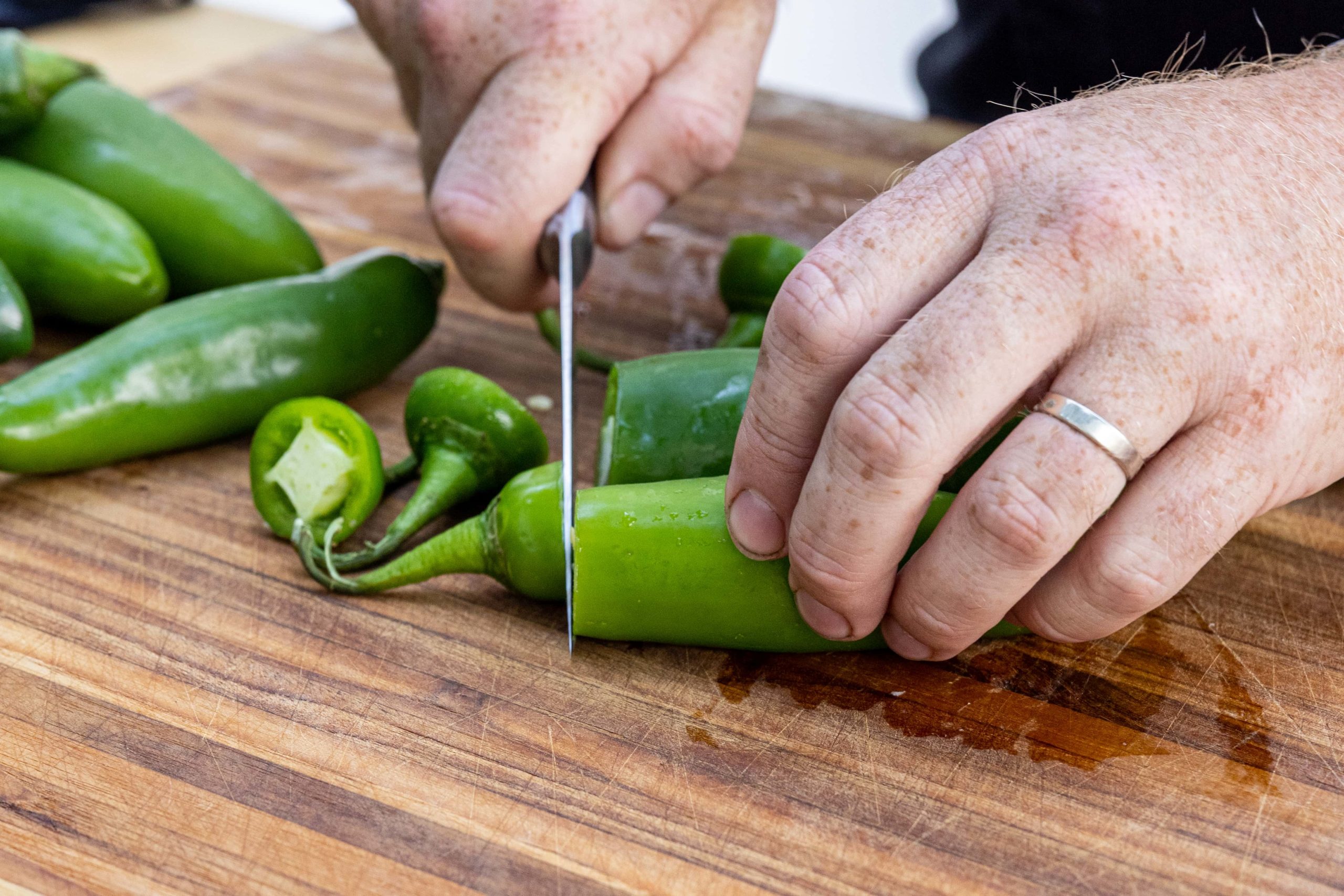 Cutting the tops from the peppers