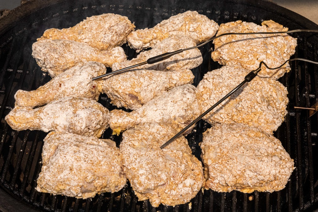 Breaded chicken on the grill with probes in it