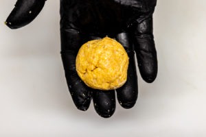 a ball of hush puppy dough ready for frying