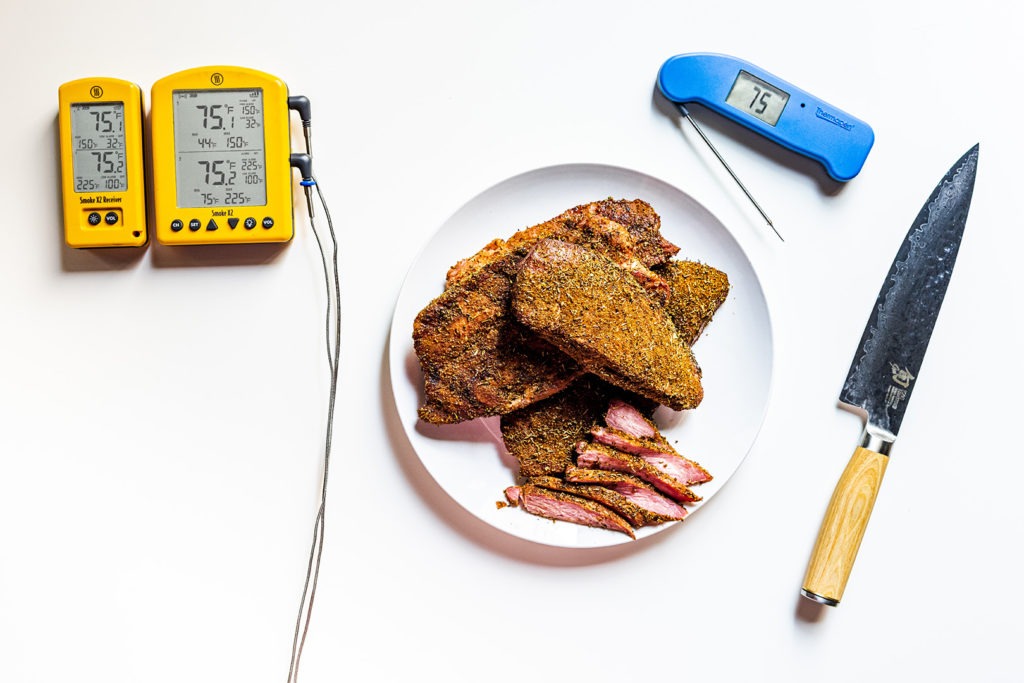 Tasso ham with thermometers and a chef's knife