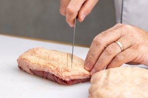 scoring the skin of a duck breast