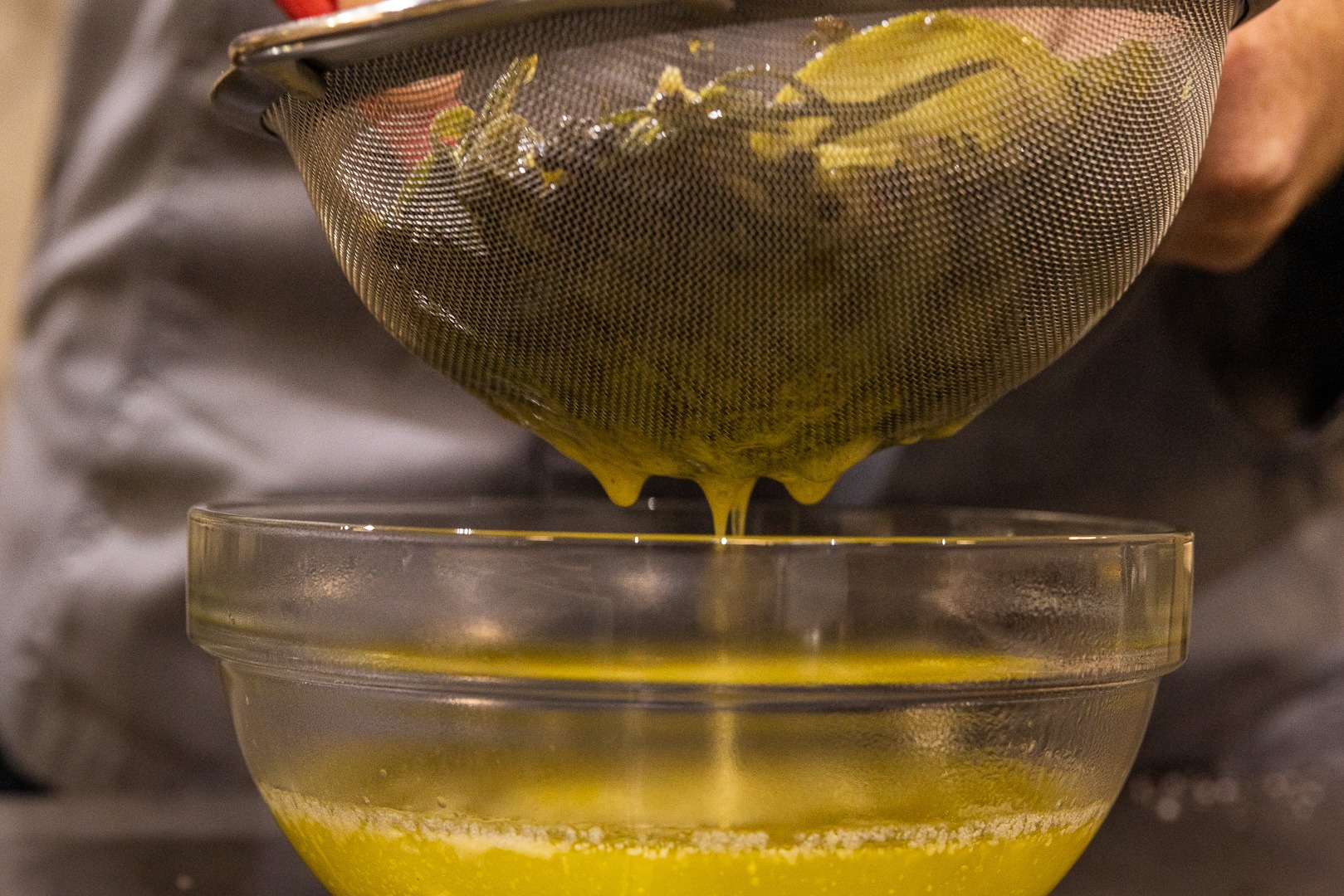 Straining the herbs from the butter