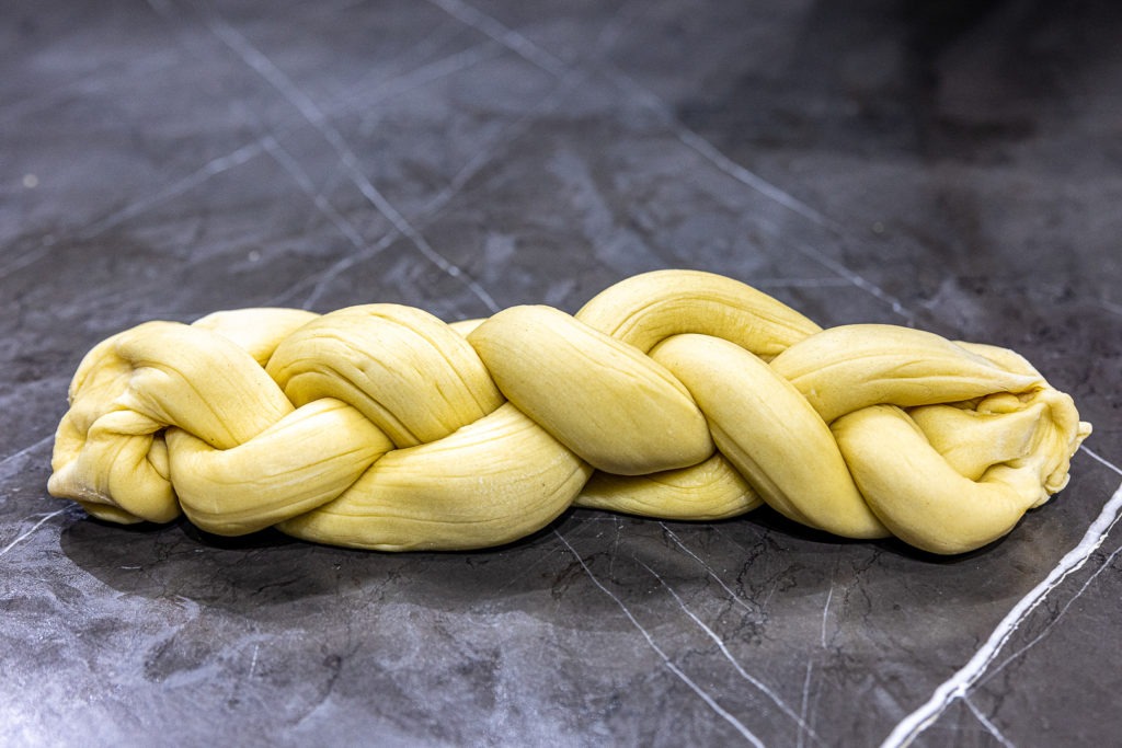 Braided challah dough ready for proofing