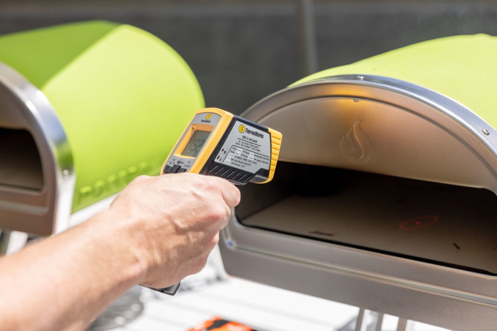 Temping the floor of the pizza oven with an IR thermometer