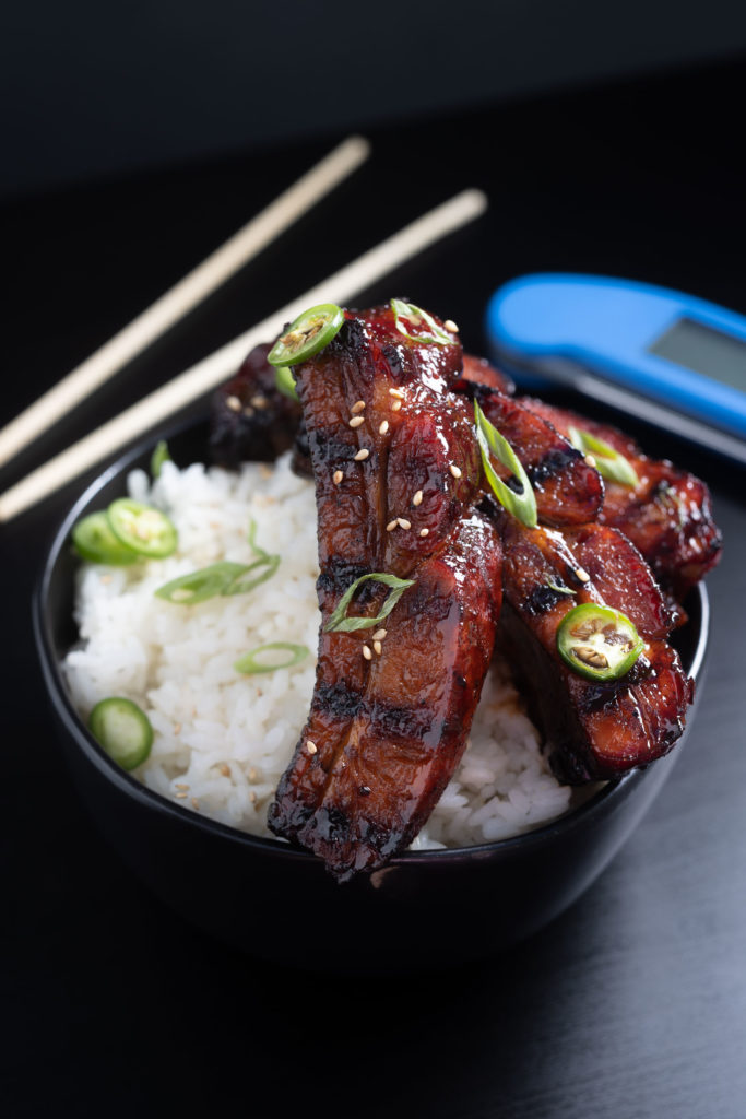 Asian sticky ribs in a bowl of rice