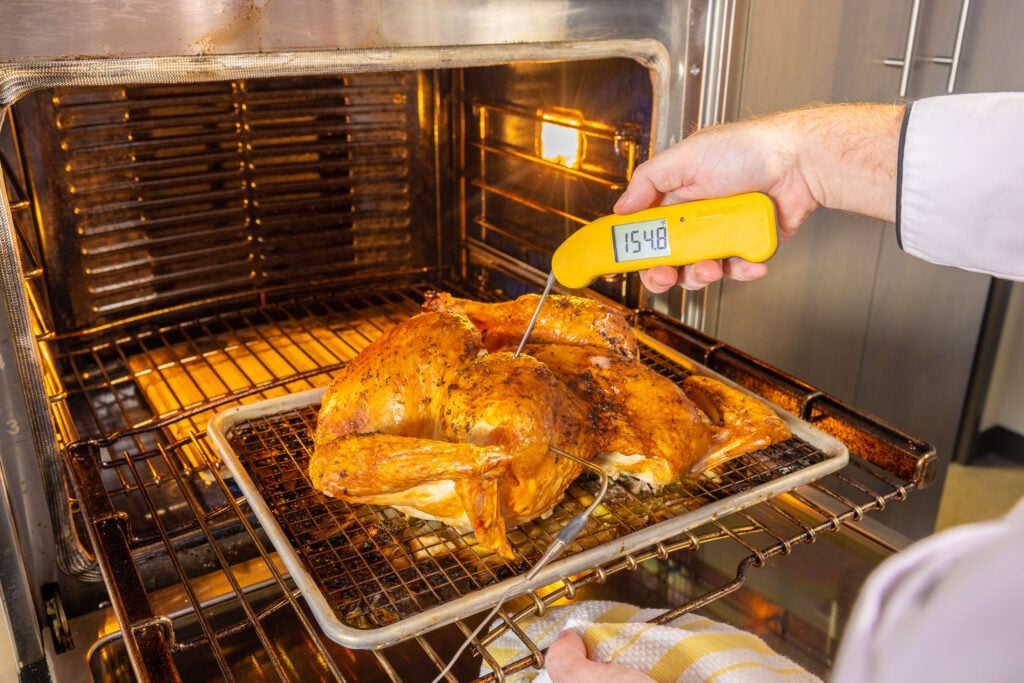 Verifying temp with Thermapen ONE in a spatchcocked turkey