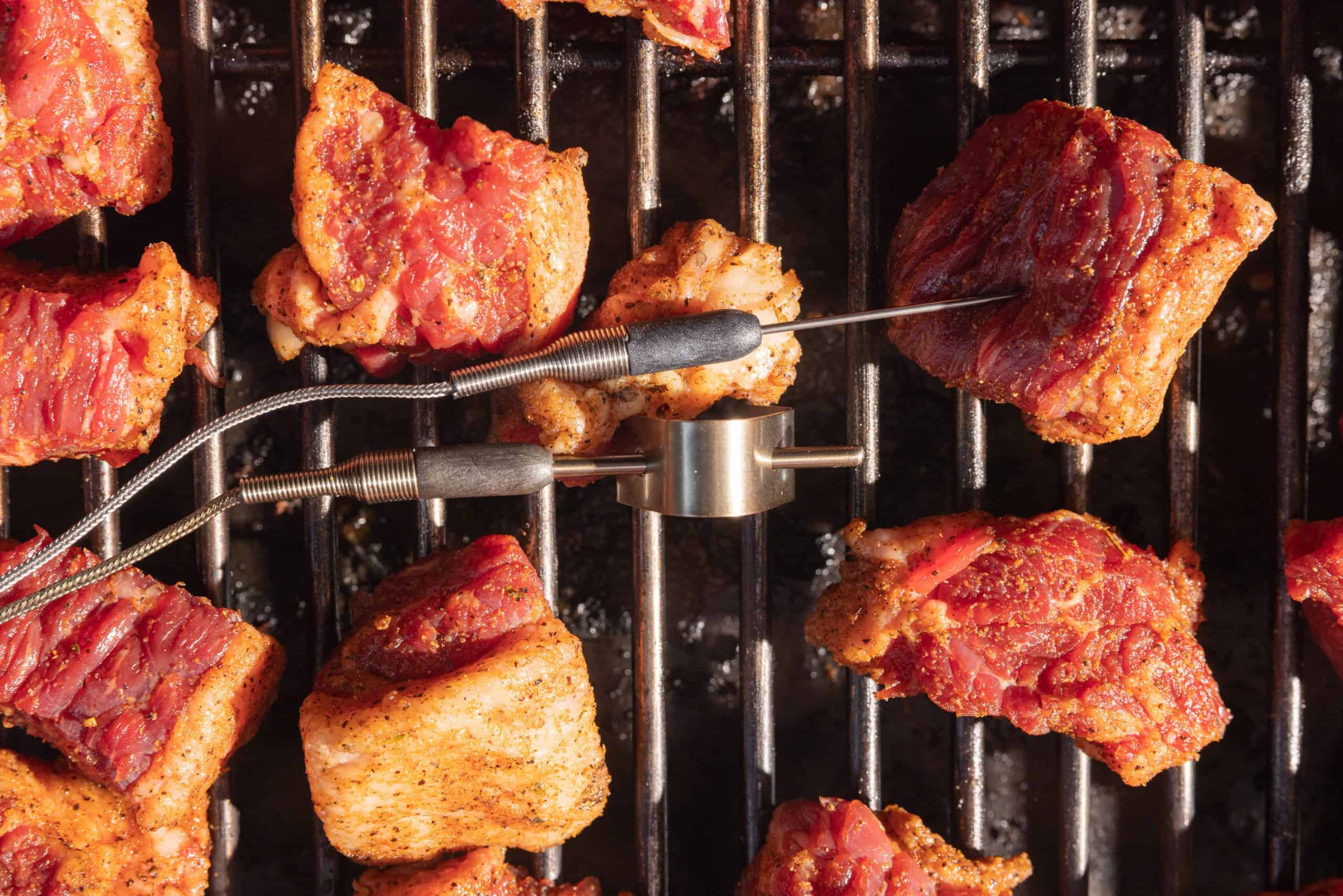 probing the meat on the smoker